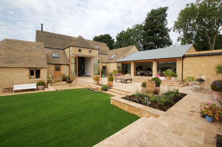 Vale Farm courtyard and garden with Cotswold stone buildings, glazed link and landscaped terraces